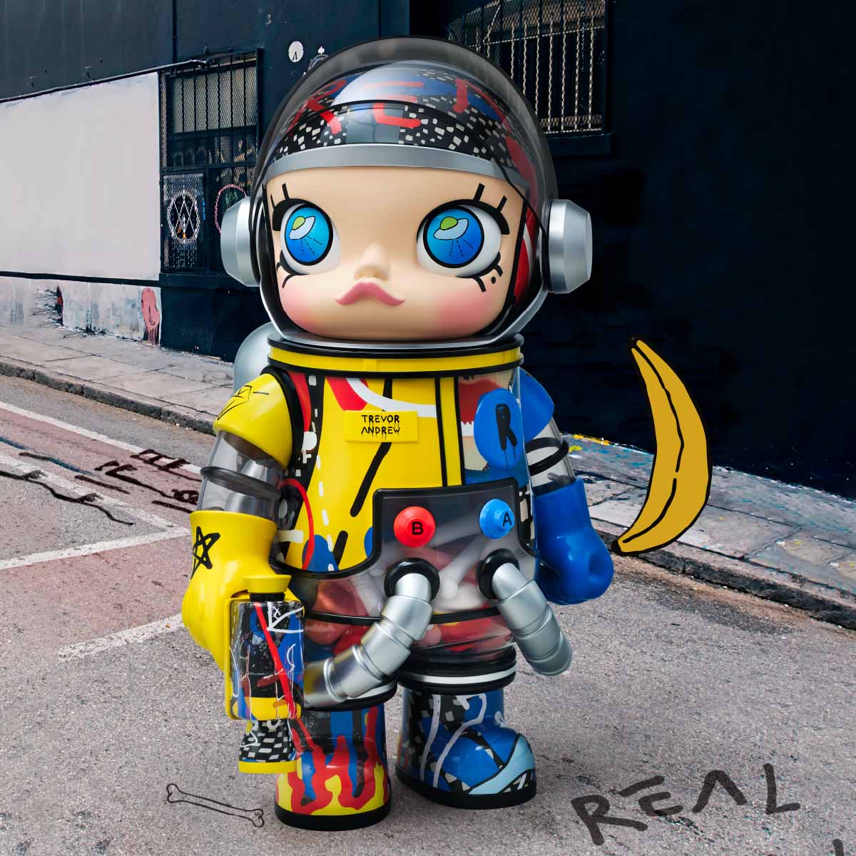 Pop Mart MEGA SPACE MOLLY 1000% Trevor Andrew colorful toy figure with helmet and space suit on a street background